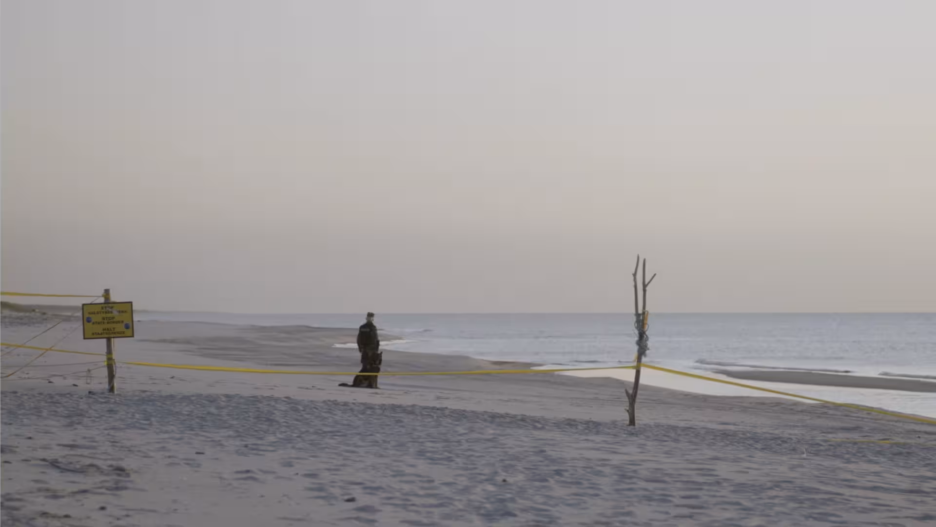 A border guard patrols the spit.