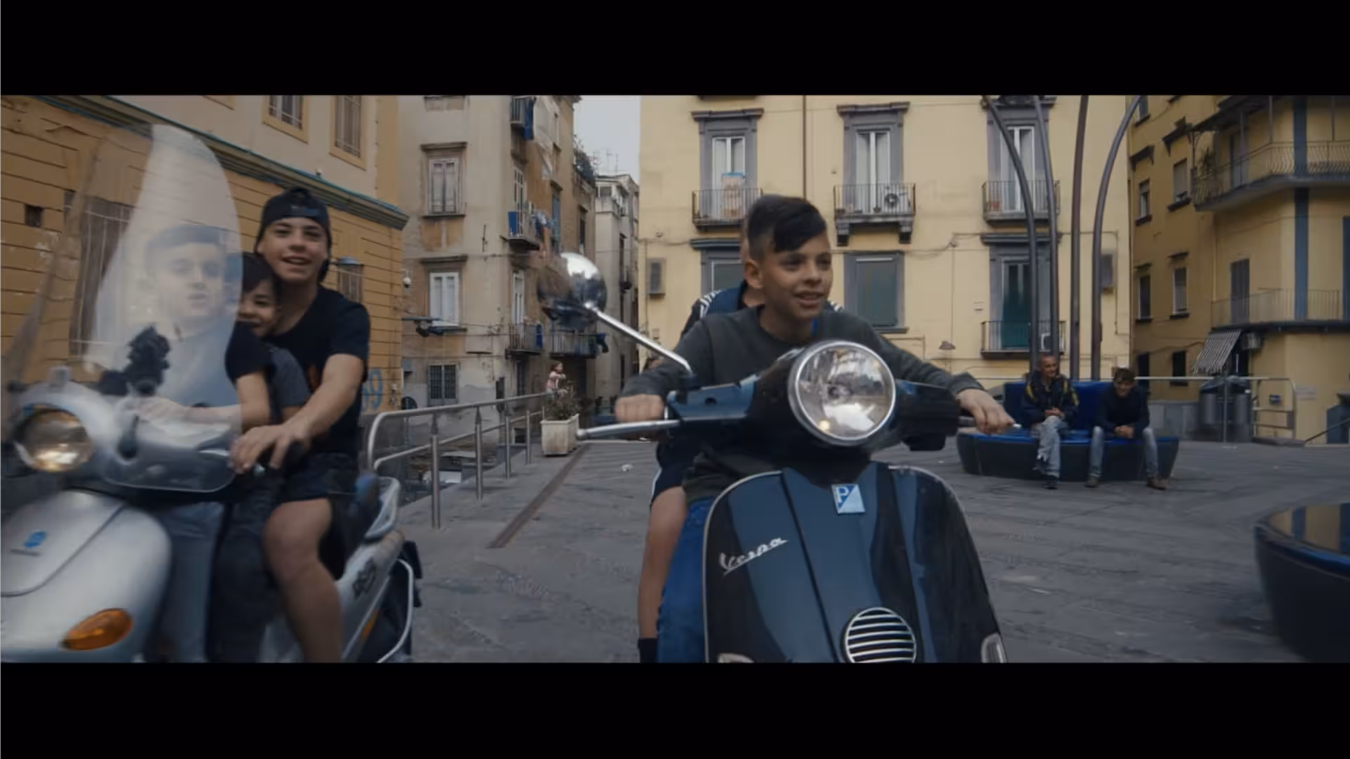 Entoni rides a scooter with friends.